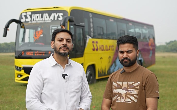 S. S Holidays team in front of their yellow GC coach