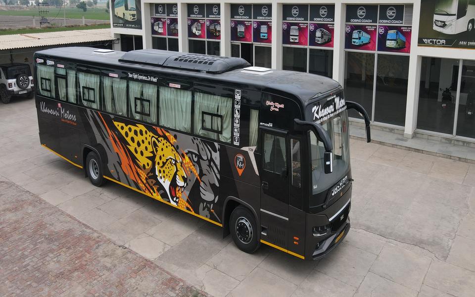 Khanouri Motors coach with a custom cheetah livery outside the GOBIND COACH showroom